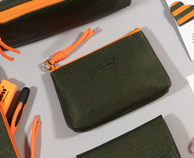 porte-monnaie berlingot taille xs, cuir graphique kaki zip contrasté fluo orange présenté avec accessoires coordonnés collection capsule